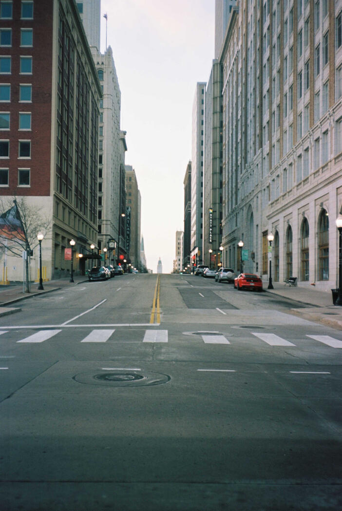 A street view of a street in Tulsa with peeks of art deco buildings.