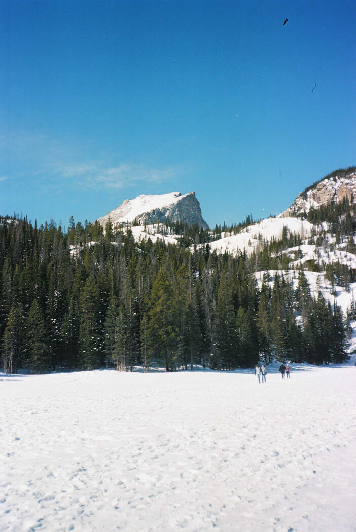 A snowy peak from the middle of a frozen lake in Rocky Mountain National Park
