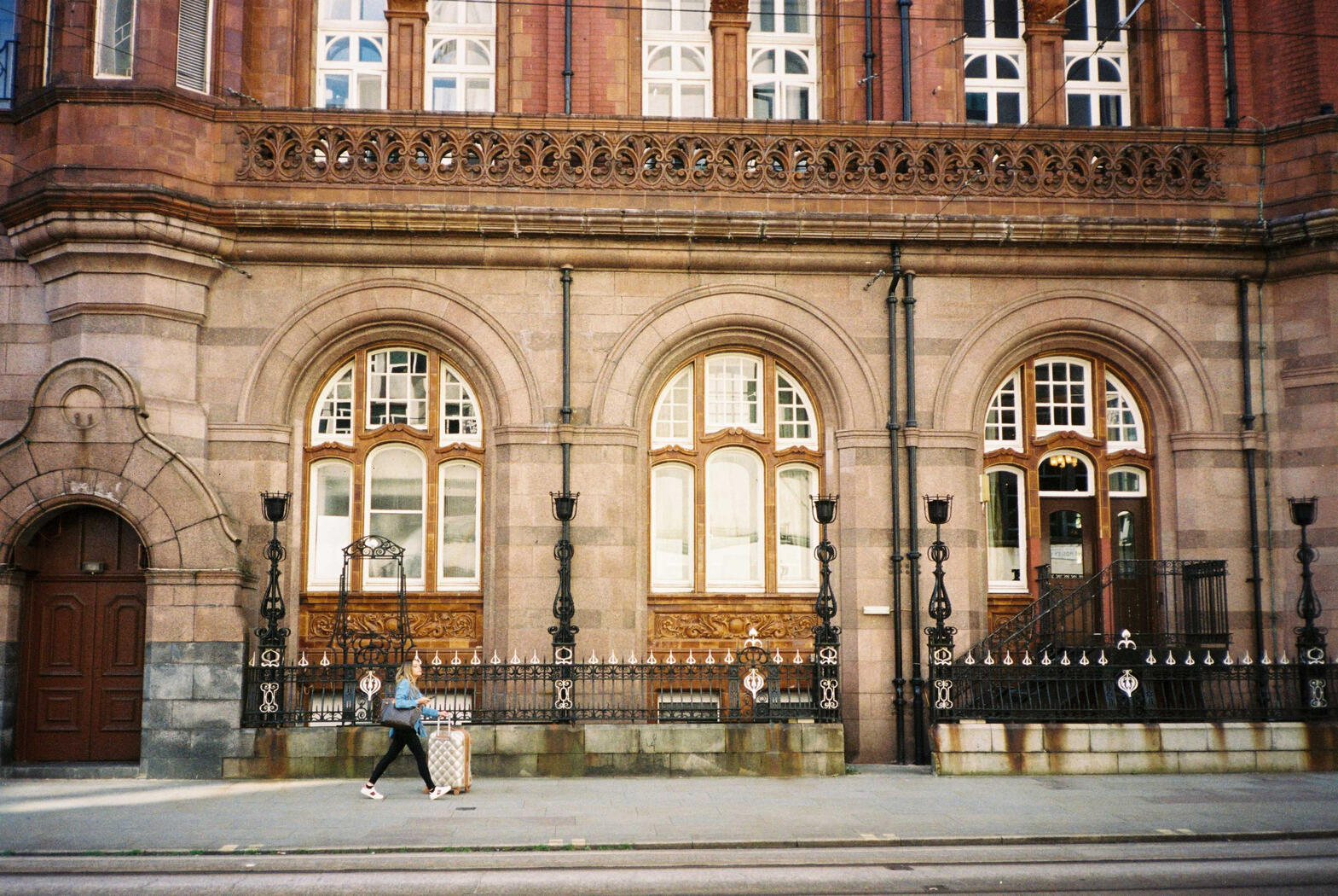 A woman walking with a suitcase